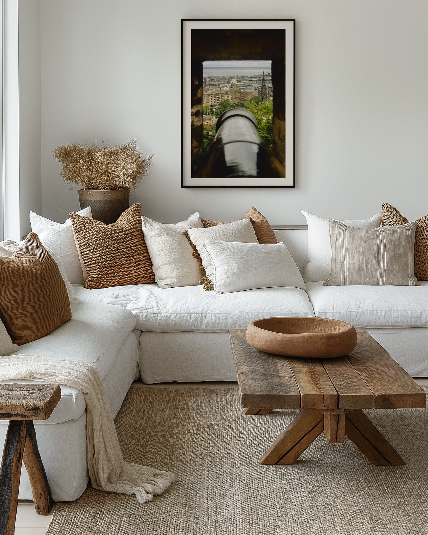 Cozy living room with a white sofa, wooden coffee table, and decorative pillows.