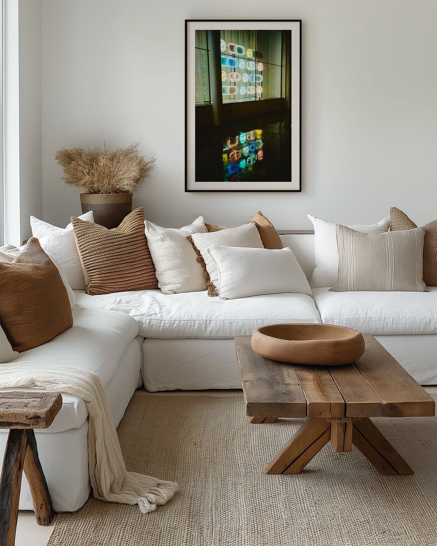 Modern living room with a white sectional sofa, wooden coffee table, and decorative pillows.