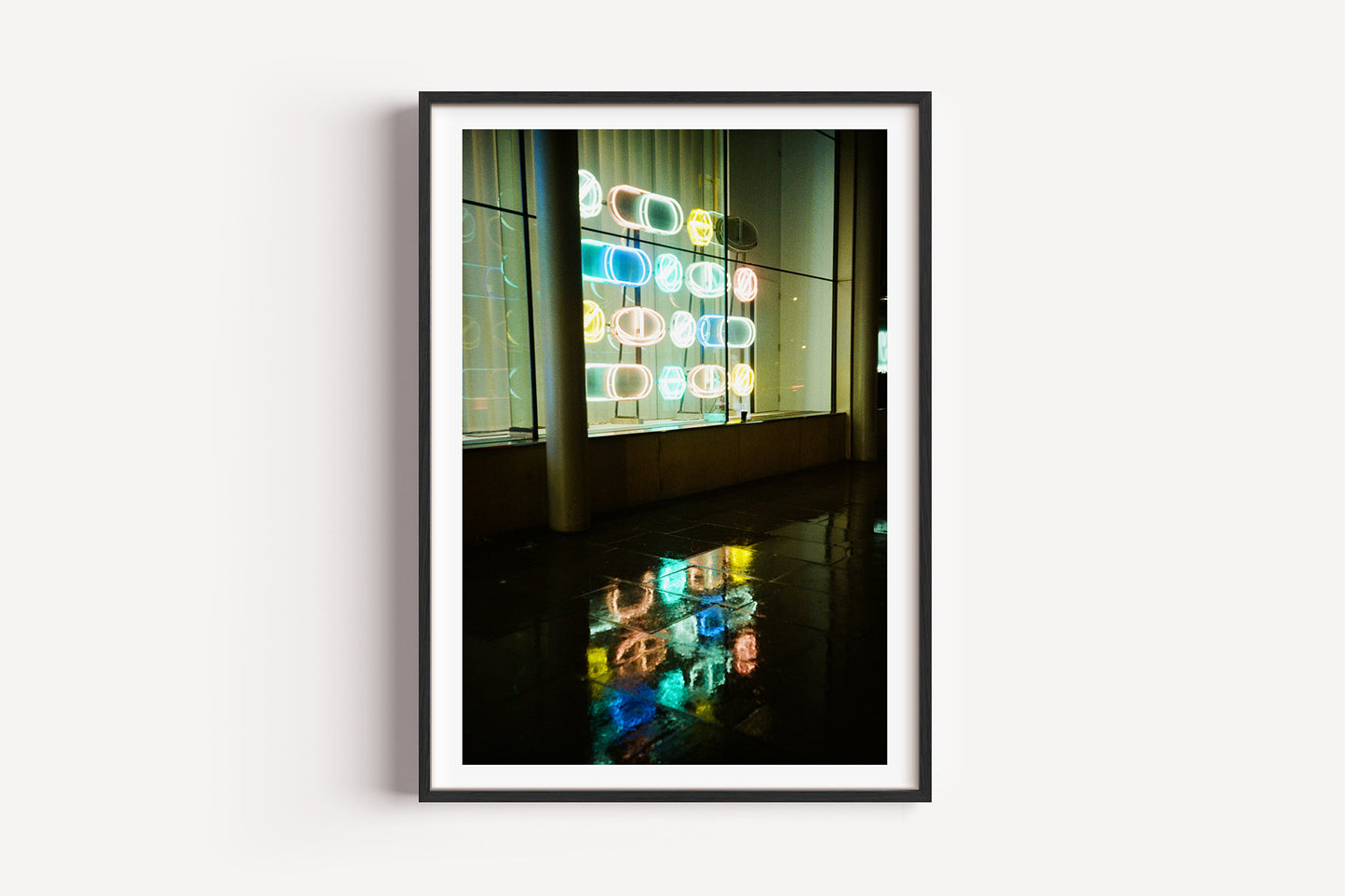 Framed photograph of colorful geometric lights on a wall