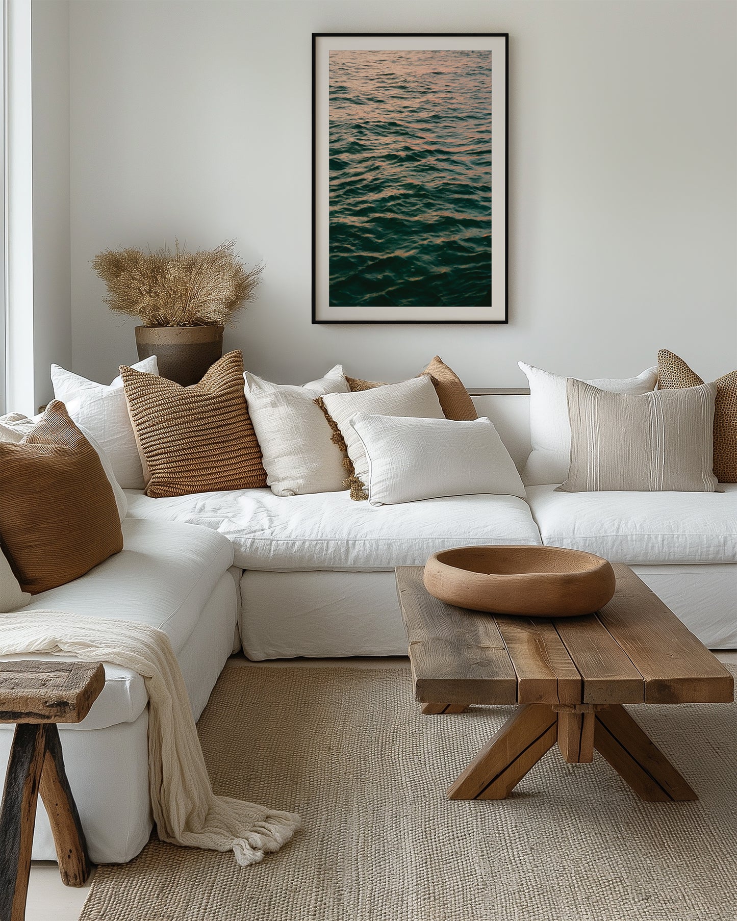 Cozy living room with a white sectional sofa, wooden coffee table, and decorative pillows.