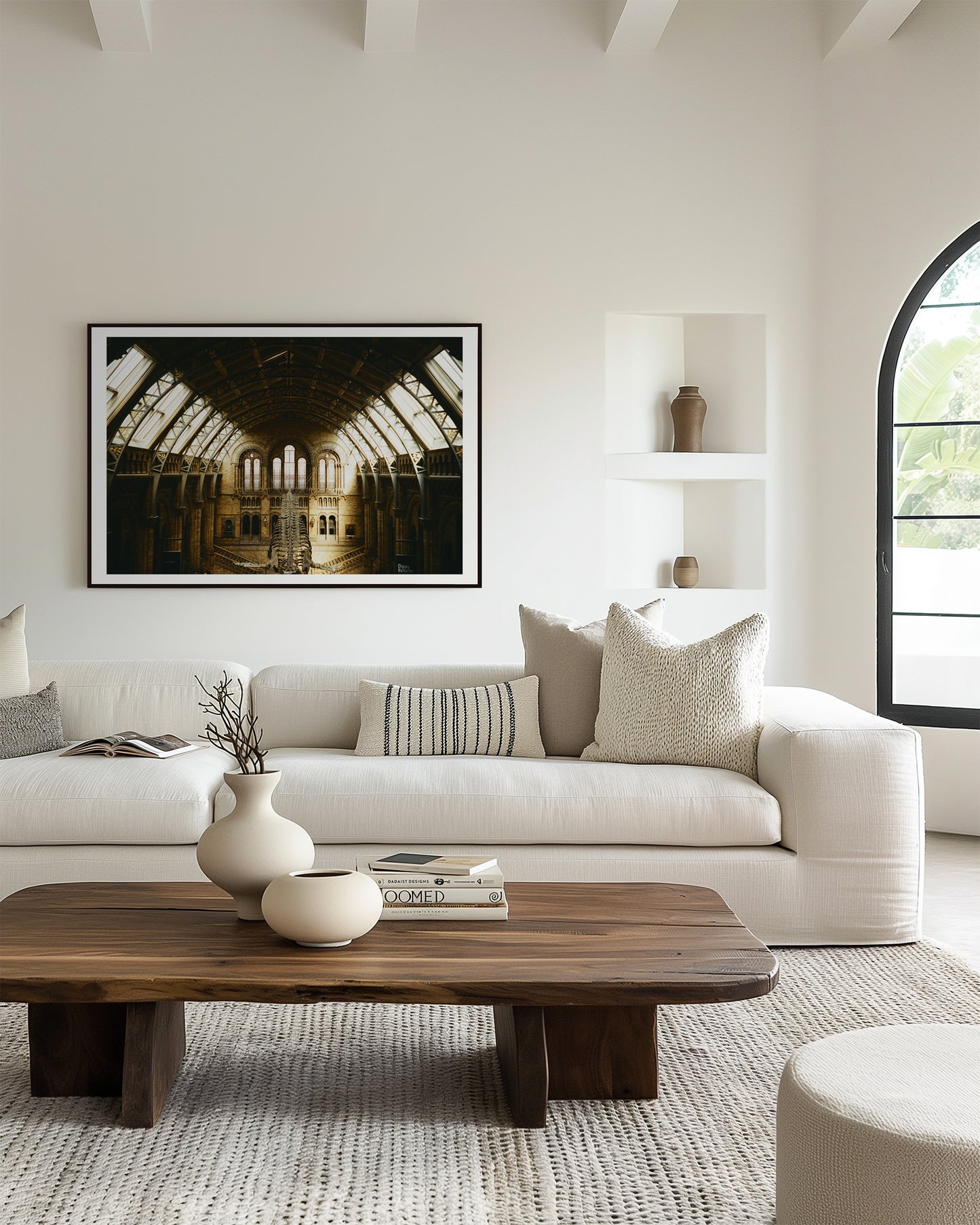 Modern living room with a white sofa, wooden coffee table, and decorative items.