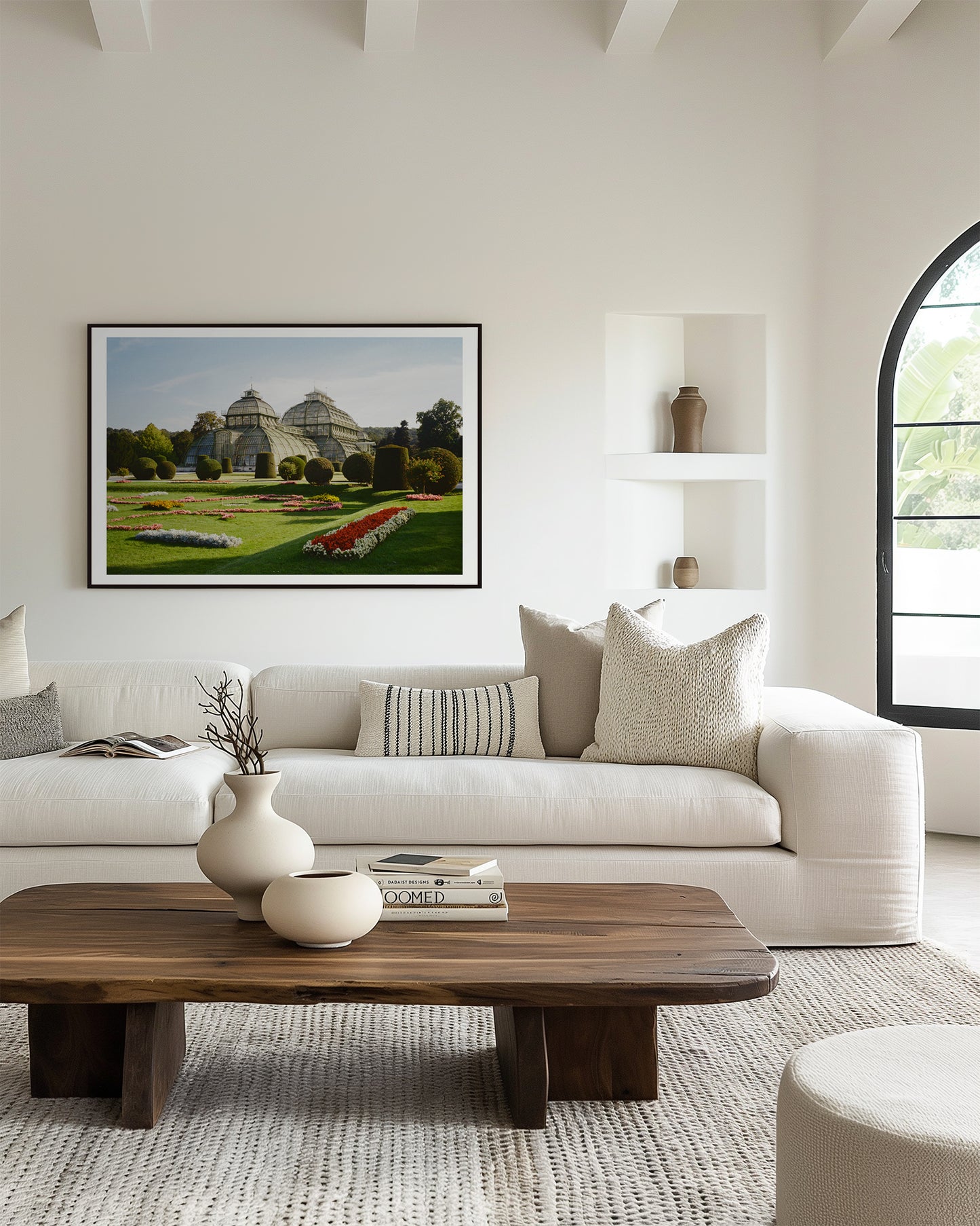 Modern living room with a white sofa, wooden coffee table, and framed picture on the wall.
