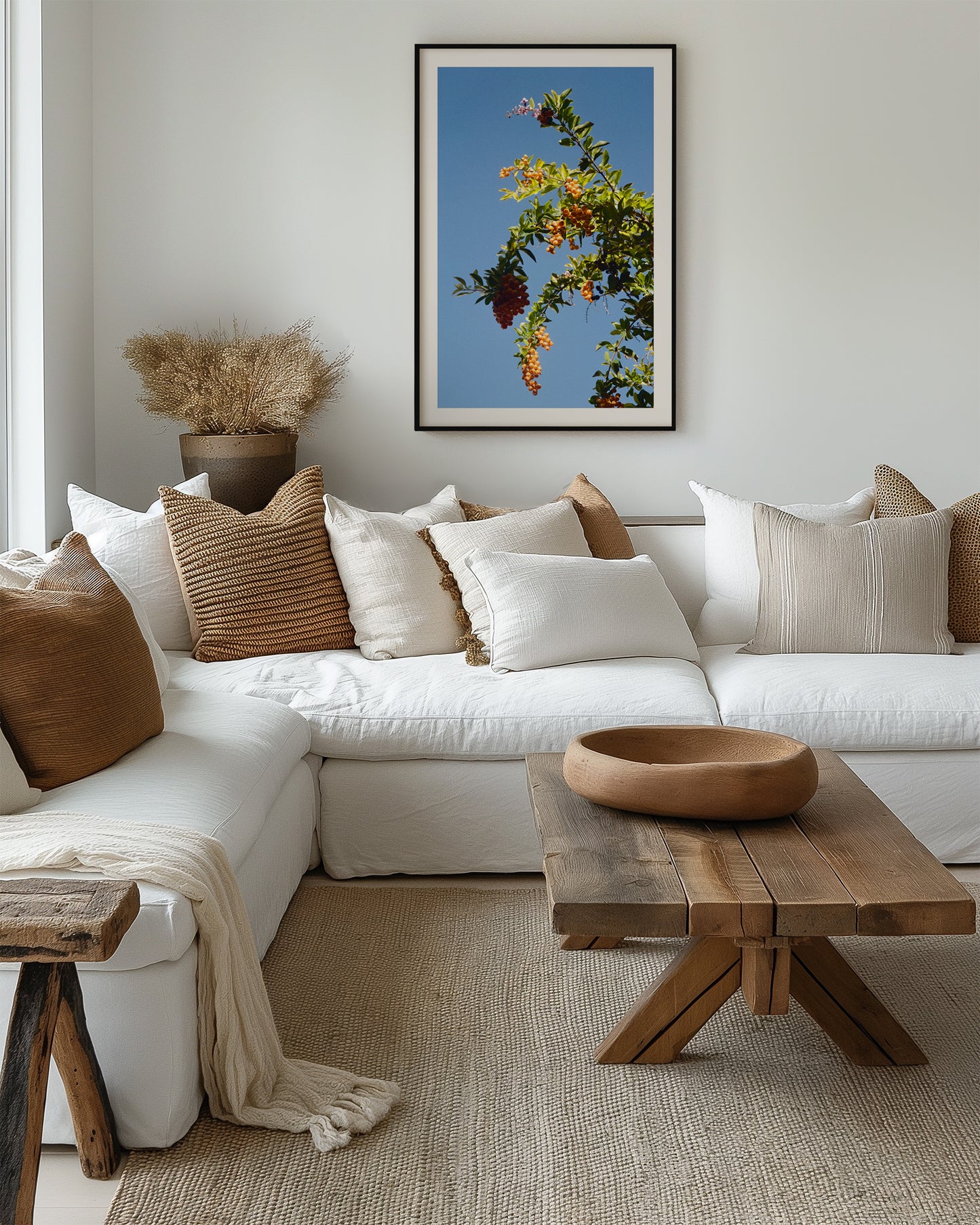 Modern living room with a white sofa, wooden coffee table, and decorative pillows.