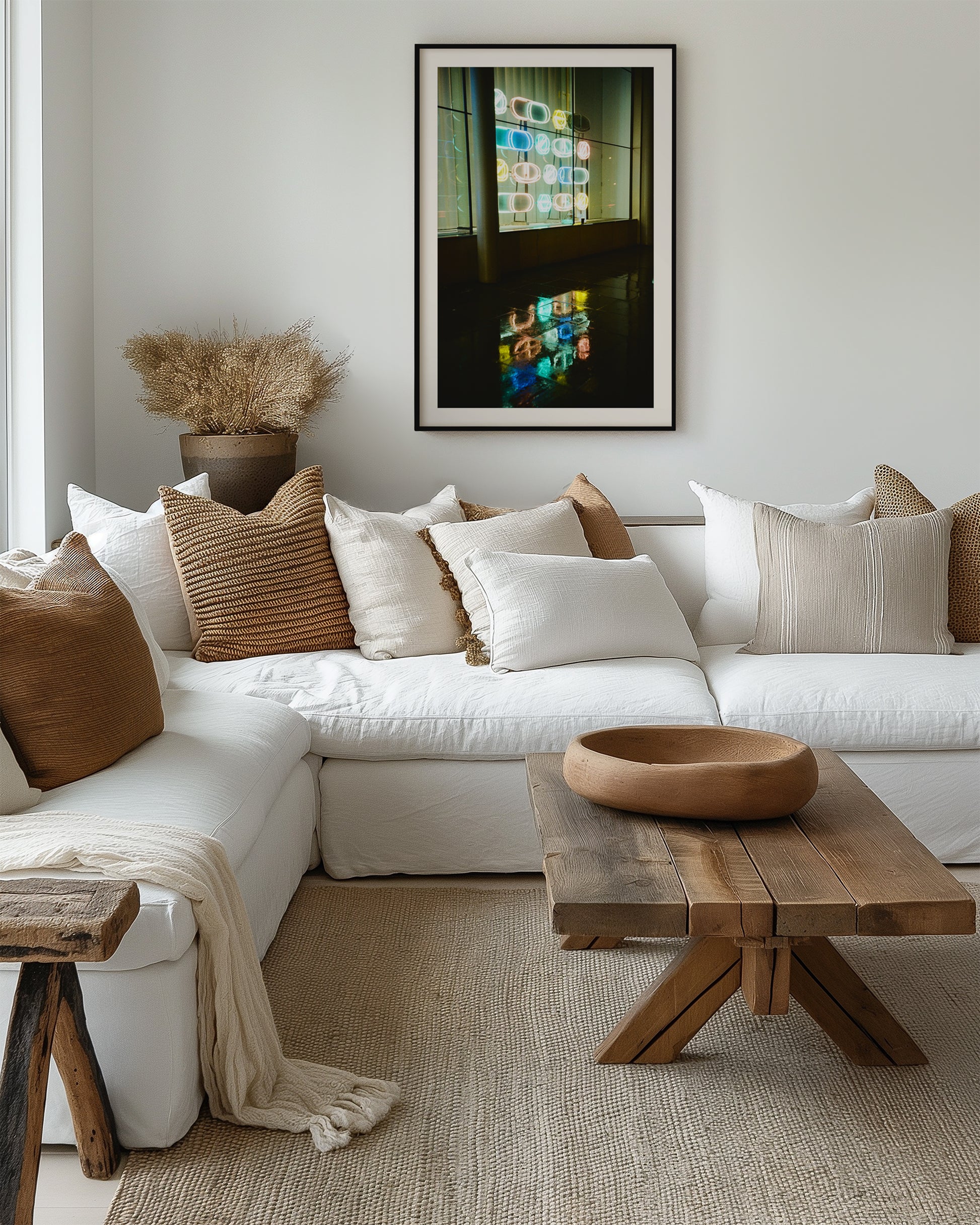 Modern living room with a white sectional sofa, wooden coffee table, and decorative pillows.
