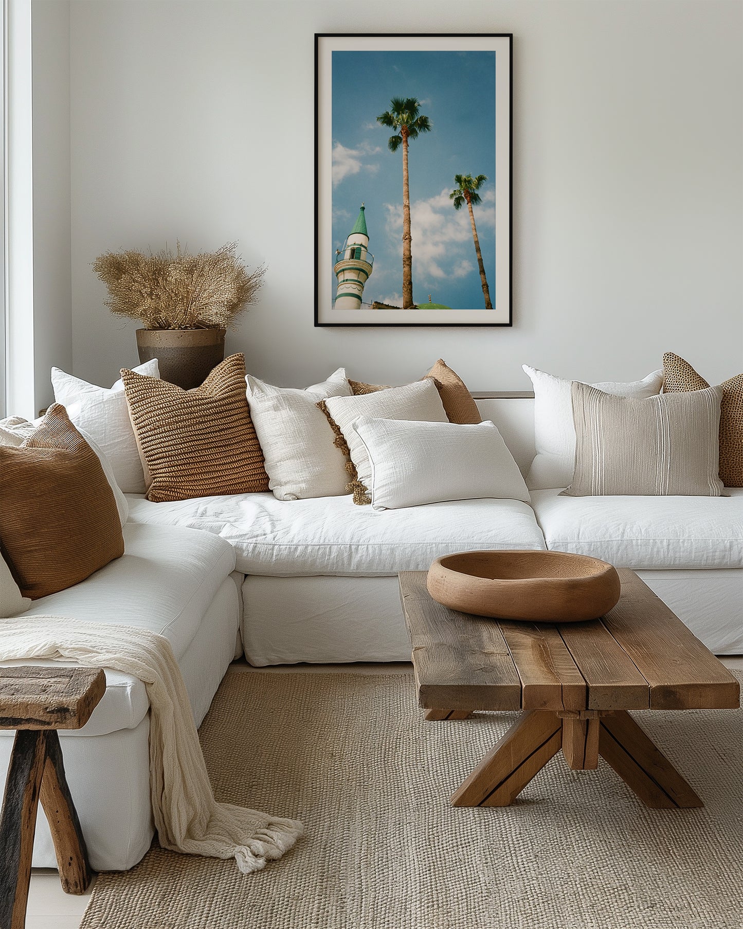 Cozy living room with a white sofa, wooden coffee table, and decorative pillows.