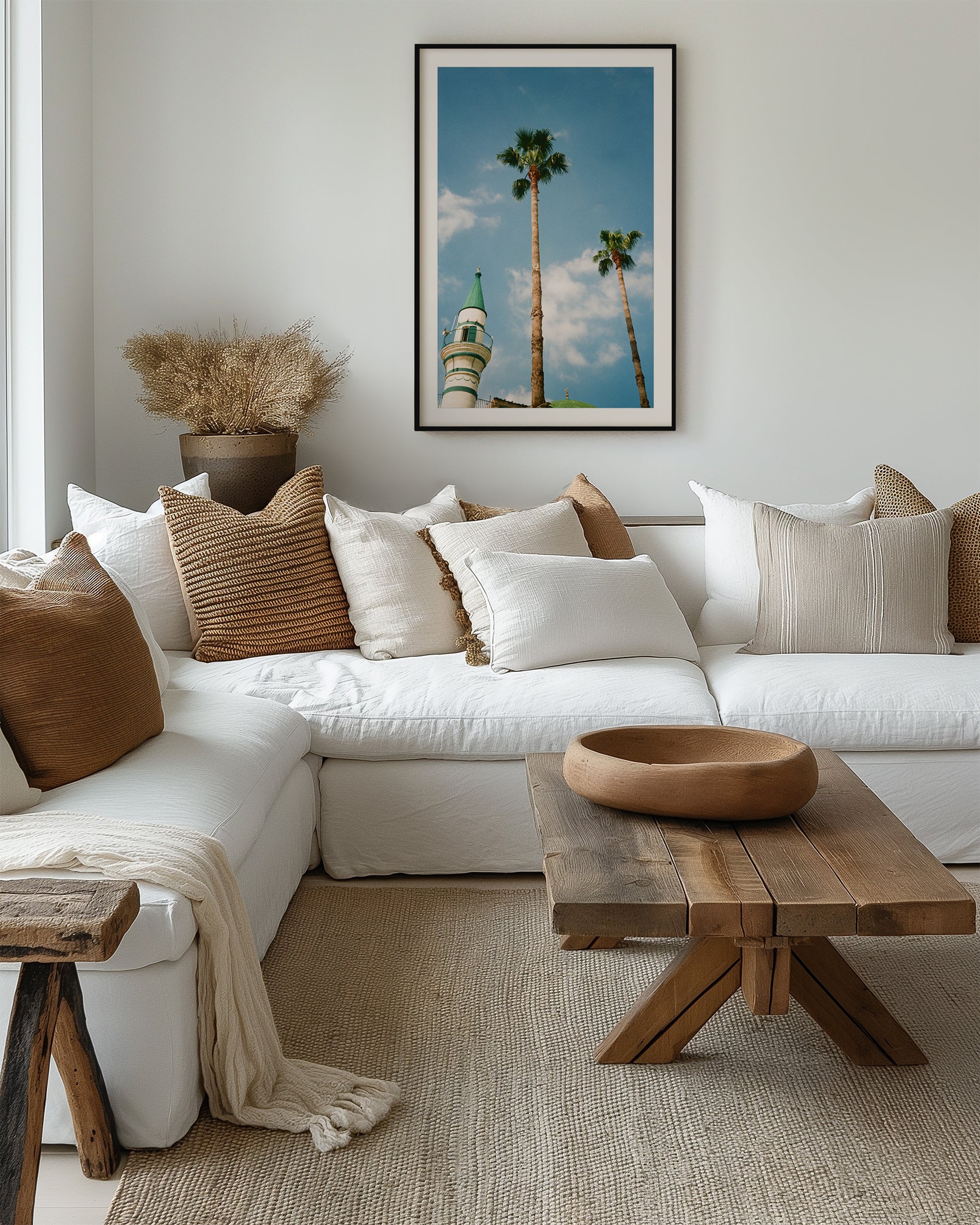 Cozy living room with a white sofa, wooden coffee table, and decorative pillows.