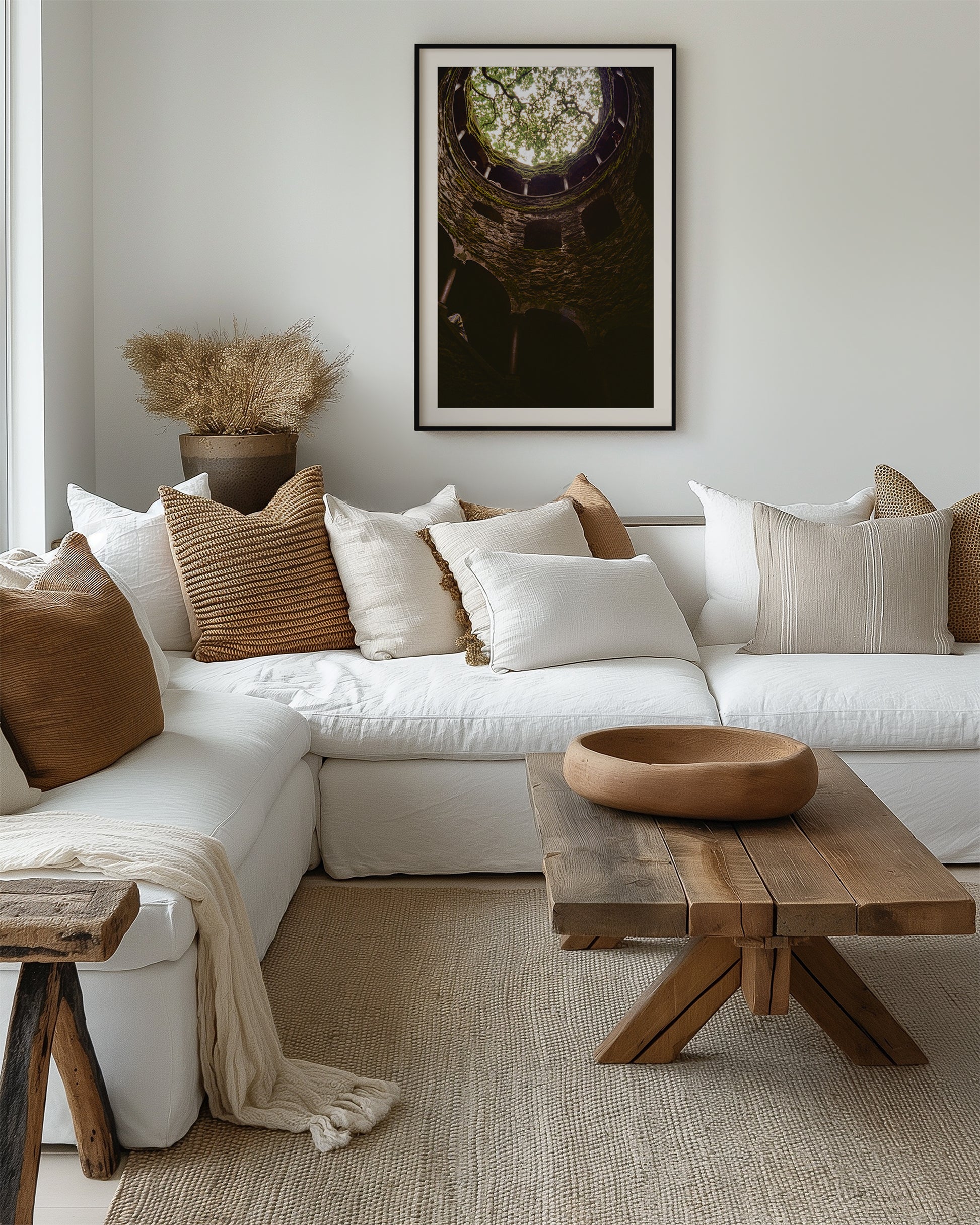Cozy living room with a white sectional sofa, wooden coffee table, and decorative pillows.