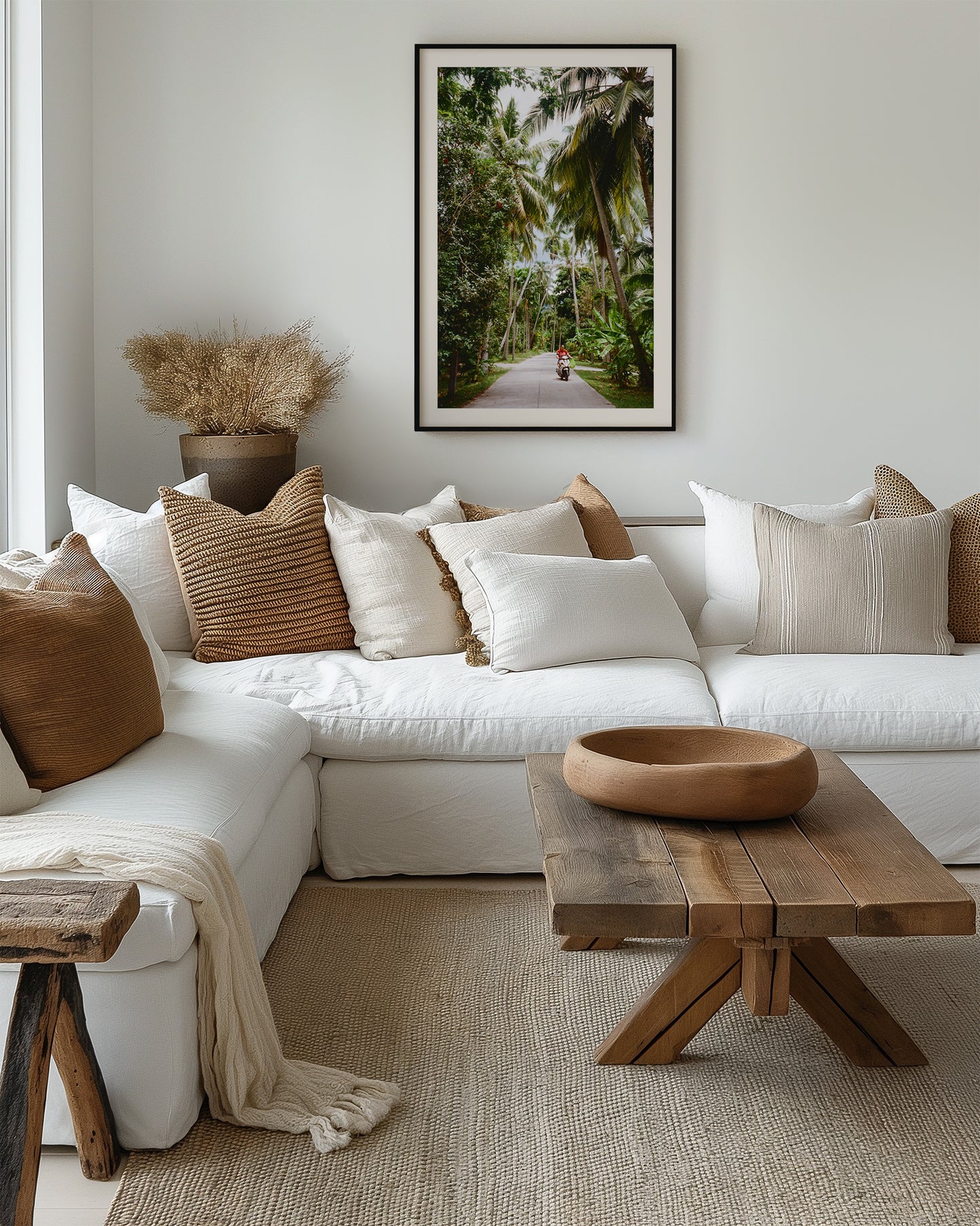 Cozy living room with a white sofa, wooden coffee table, and decorative pillows.