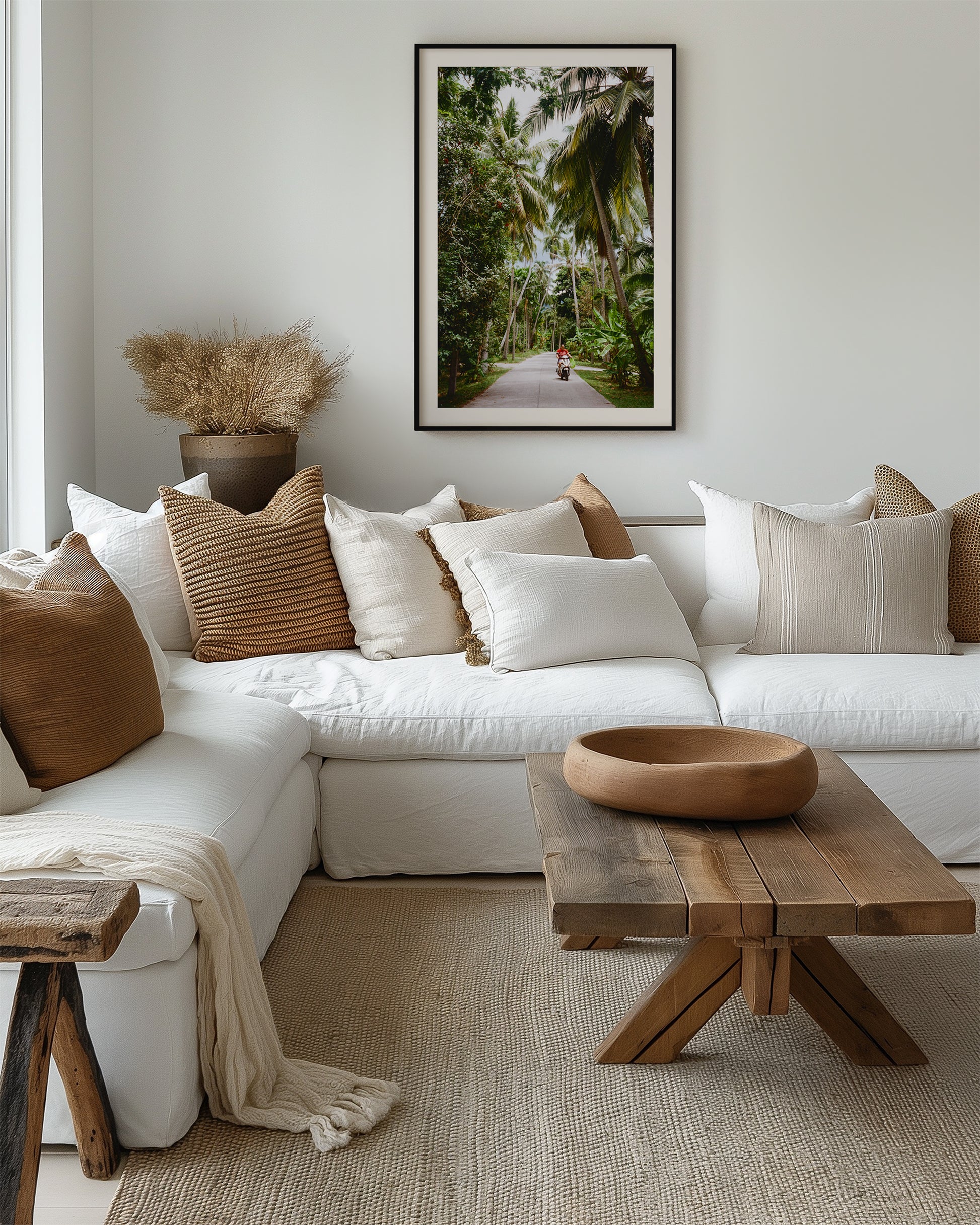 Cozy living room with a white sofa, wooden coffee table, and decorative pillows.