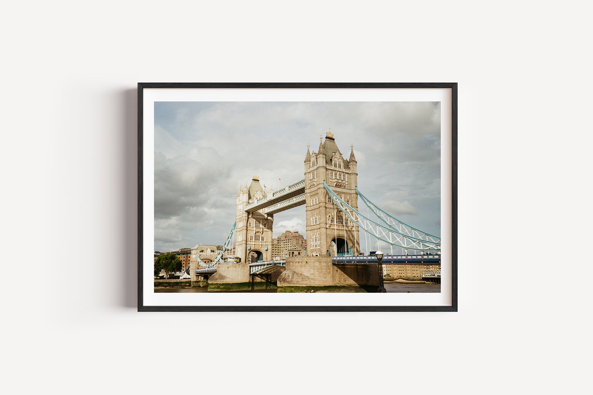 Framed photograph of Tower Bridge under a cloudy sky