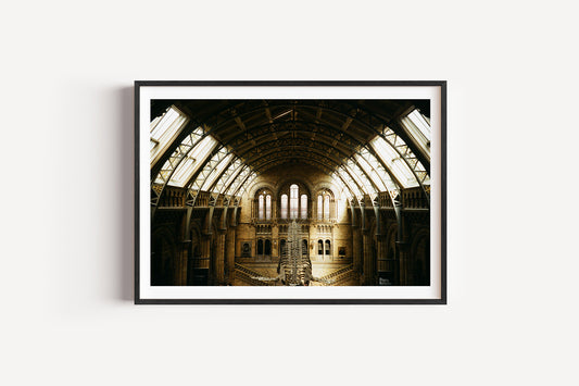 Framed photograph of a large, open architectural space with high ceilings and large windows.
