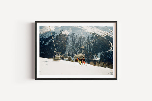 Framed photograph of a snowy mountain landscape with ski lifts and people.